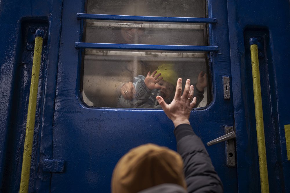  Stanislav says goodbye to his two-year-old son David and wife Anna after they boarded a train that will take them to Lviv, from the station in Kyiv, Ukraine, Thursday, March 3. 2022. Stanislav stayed to fight as his family sought refuge in a neighbo
