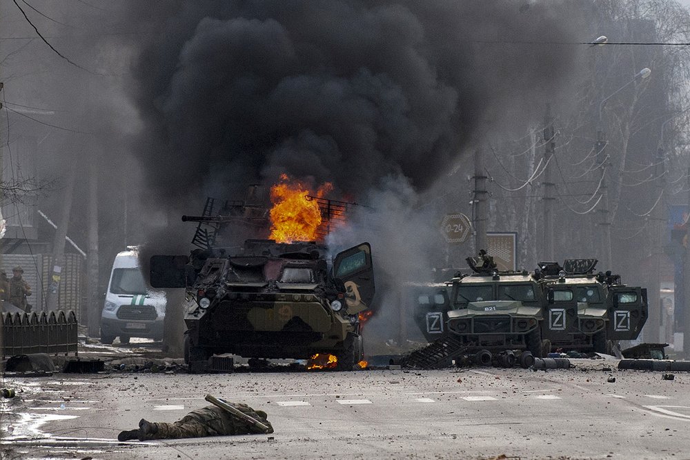  A Russian armored personnel carrier burns amid damaged and abandoned light utility vehicles after fighting in Kharkiv, Ukraine, Sunday, Feb. 27, 2022. (AP Photo/Marienko Andrew) 