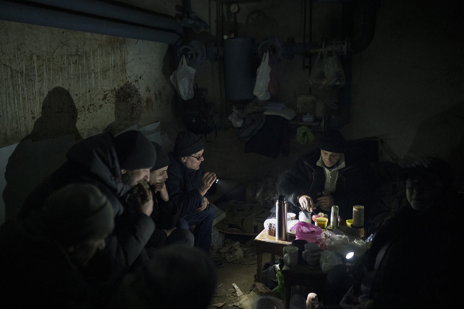  Residents prepare tea in a basement being used as a bomb shelter in Irpin, on the outskirts of Kyiv, Ukraine, Sunday, March 13, 2022. (AP Photo/Felipe Dana) 