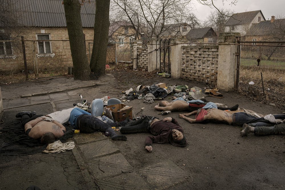  GRAPHIC CONTENT - Bodies lie on the ground, some with their hands tied behind their backs, in Bucha, Ukraine, Sunday, April 3, 2022. AP journalists saw the bodies of at least 21 people in various spots around Bucha. One group of nine, all in civilia