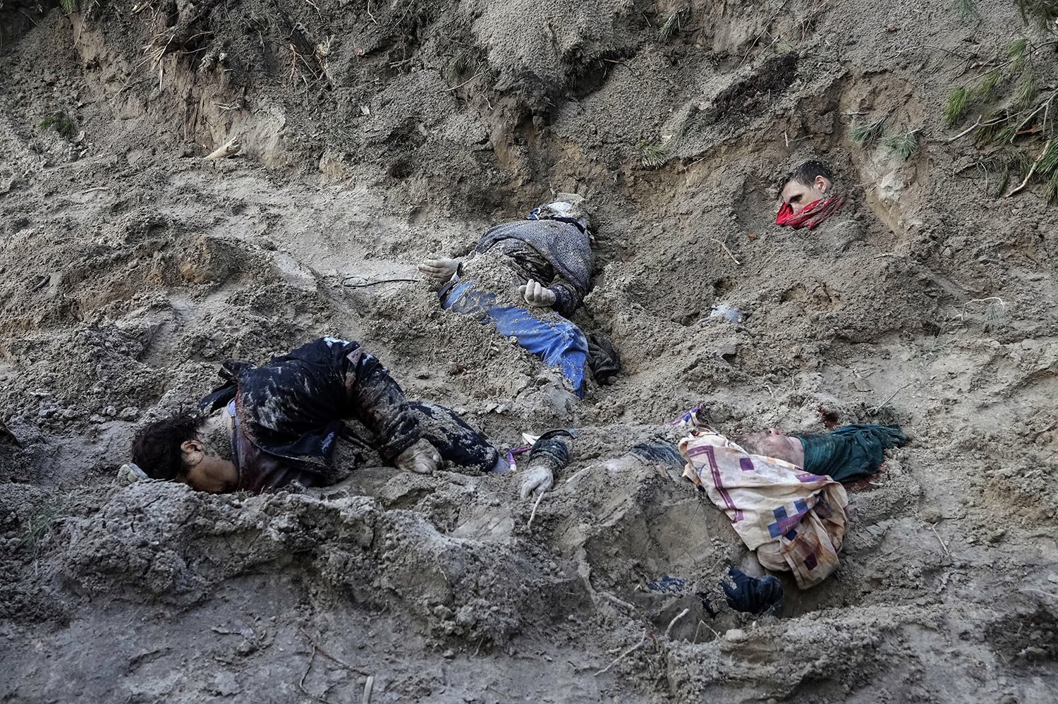  GRAPHIC CONTENT - Four bodies lie in a mass grave, including the village mayor and her family, in Motyzhyn close to Kyiv, Ukraine, Monday, April 4, 2022, after Russian army were pushed out from the area by Ukrainian forces. The bodies appeared to ha