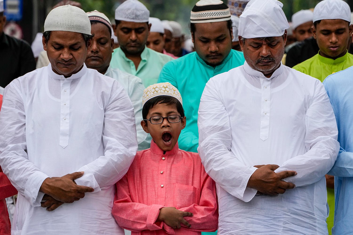  A Muslim boy yawns as he offers prayers with others on Eid al-fitr in Kolkata, India, Tuesday, May 3, 2022.  (AP Photo/Bikas Das) 