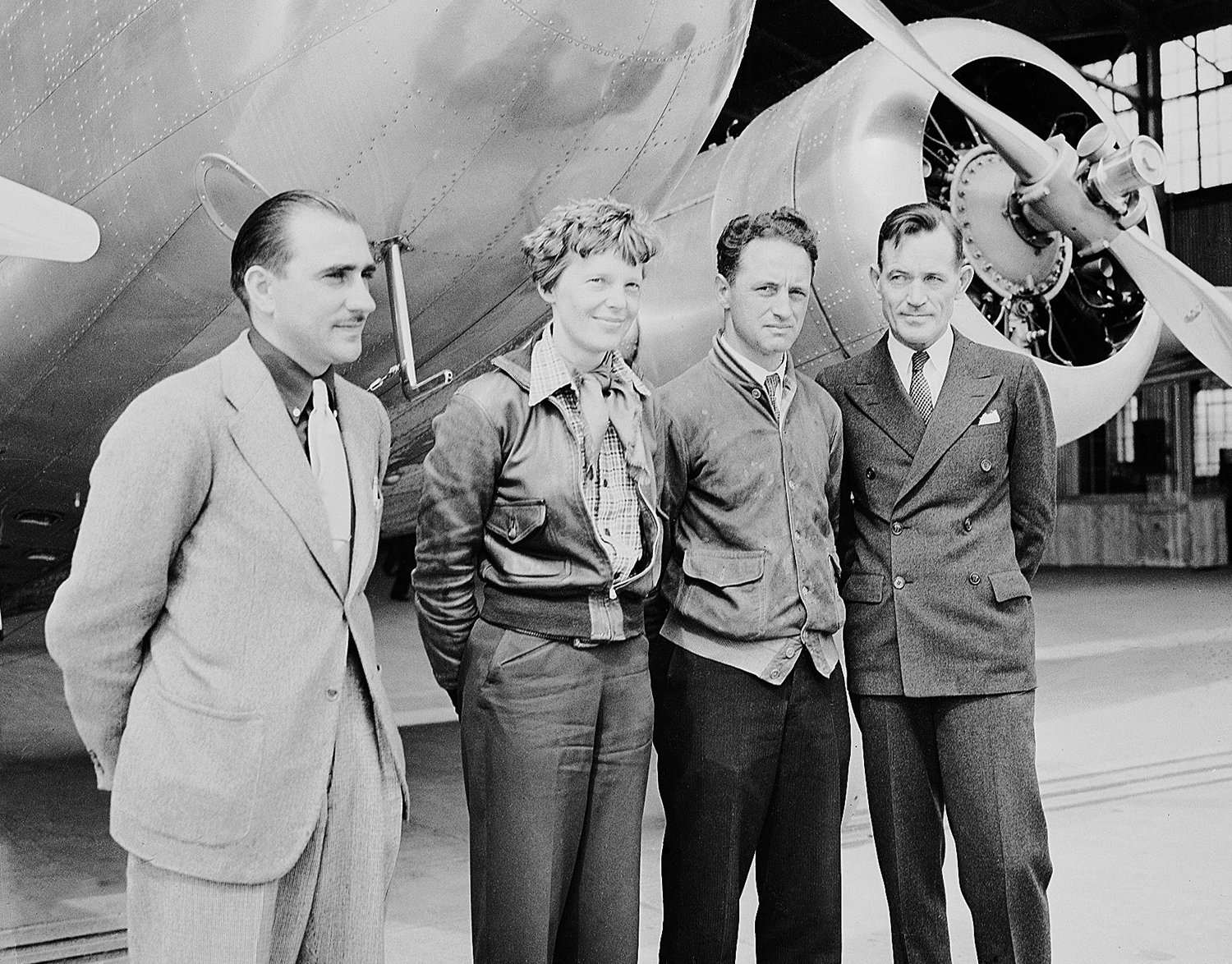  Aviator Amelia Earhart stands with members of her flight team in Honolulu, Hawaii in 1937. From left are Paul Mantz, technical adviser, Earhart, navigators Harry Manning and Fred Noonan.  (AP Photo) 