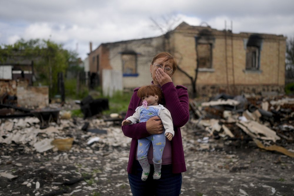  Nila Zelinska holds her granddaughter's doll that she recovered from her destroyed home  in Potashnya, on the outskirts of Kyiv, Ukraine, Tuesday, May 31, 2022. Zelinska returned after escaping war to find out she is now homeless. (AP Photo/Natacha 