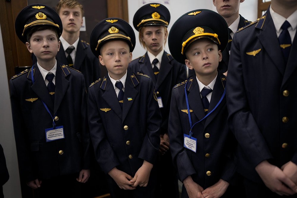  Children in train guard uniforms wait for the departure of a children's train in Kyiv, Ukraine, Saturday, June 4, 2022. The Children's Railways, that lets children drive trains and learn about working the railways, started to run again Saturday arou