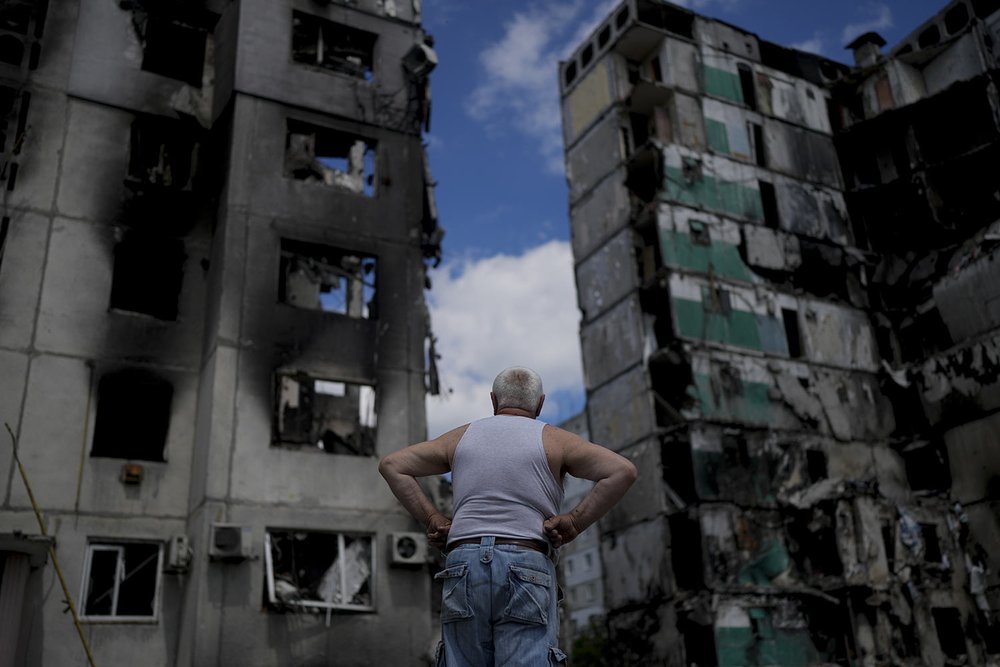  A man looks at buildings destroyed during Russian attacks on Borodyanka on the outskirts of Kyiv, Ukraine, Saturday, June 4, 2022. (AP Photo/Natacha Pisarenko) 