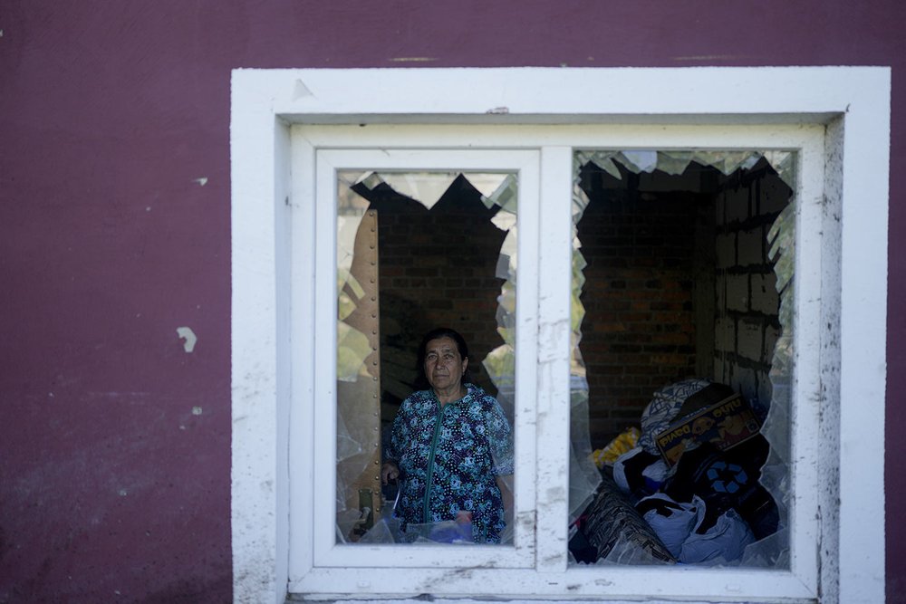  Nastasia Vladimirovna poses for a portrait from inside her home, destroyed by Russian attacks in Mostyshche on the outskirts of Kyiv, Ukraine, Monday, June 6, 2022. Vladimirovna said she lived here with 18 family members, but now she and her husband