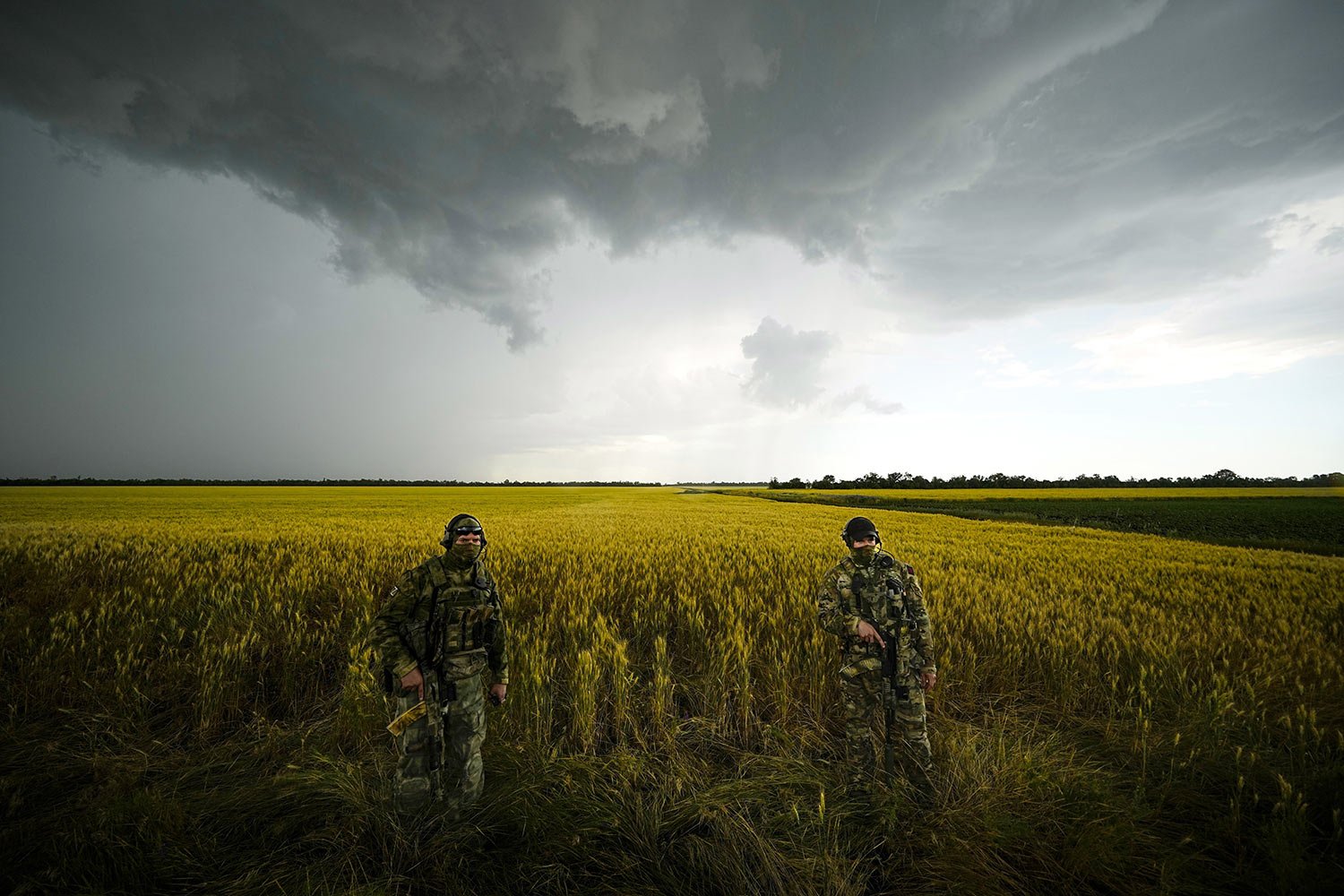  Russian soldiers guard an area next to a field of wheat as foreign journalists work in the Zaporizhzhia region in an area under Russian military control, southeastern Ukraine, Tuesday, June 14, 2022. The Zaporizhzhia region has been under control of