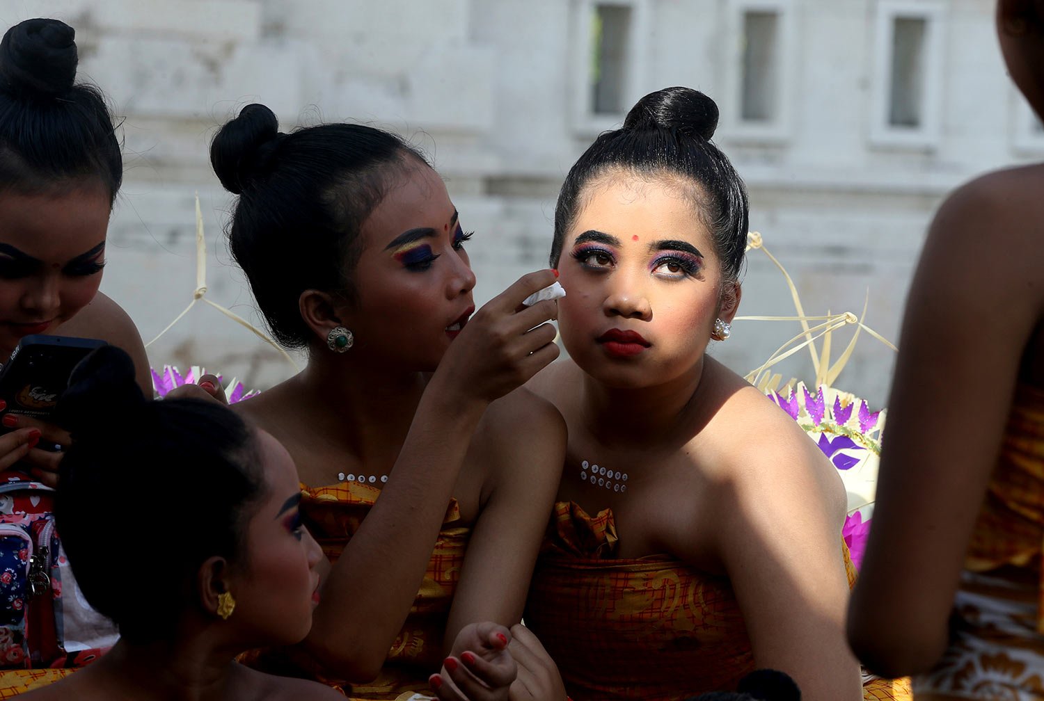  Young female dancers stand by for their performance during the Kuningan festival at Sakenan temple in Bali, Indonesia, Saturday, June 18, 2022.  (AP Photo/Firdia Lisnawati) 