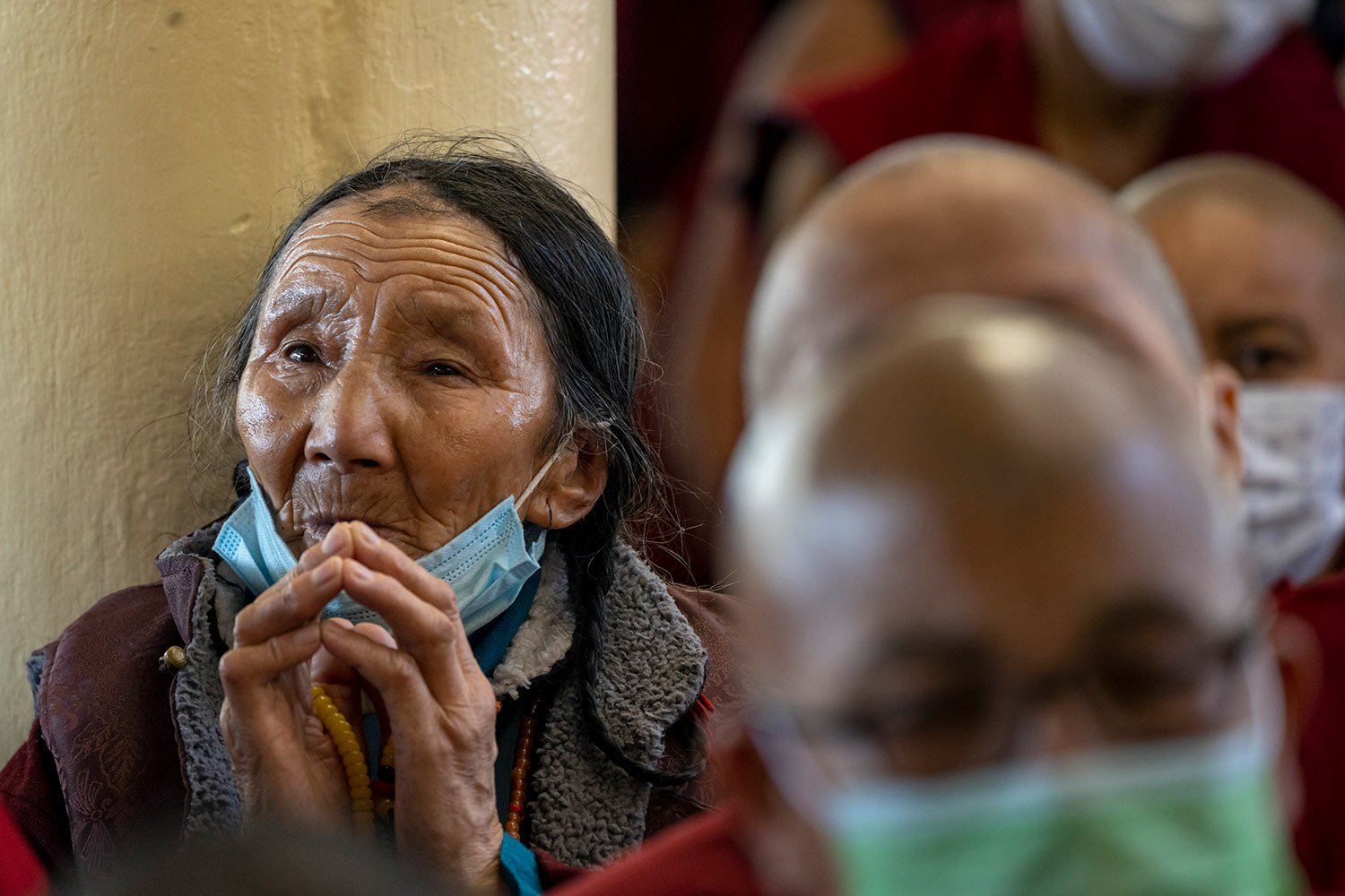  An exile Tibetan listens to her spiritual leader the Dalai Lama speak at the Tsuglakhang temple in Dharmsala, India, Wednesday, June 1, 2022. . (AP Photo/Ashwini Bhatia) 