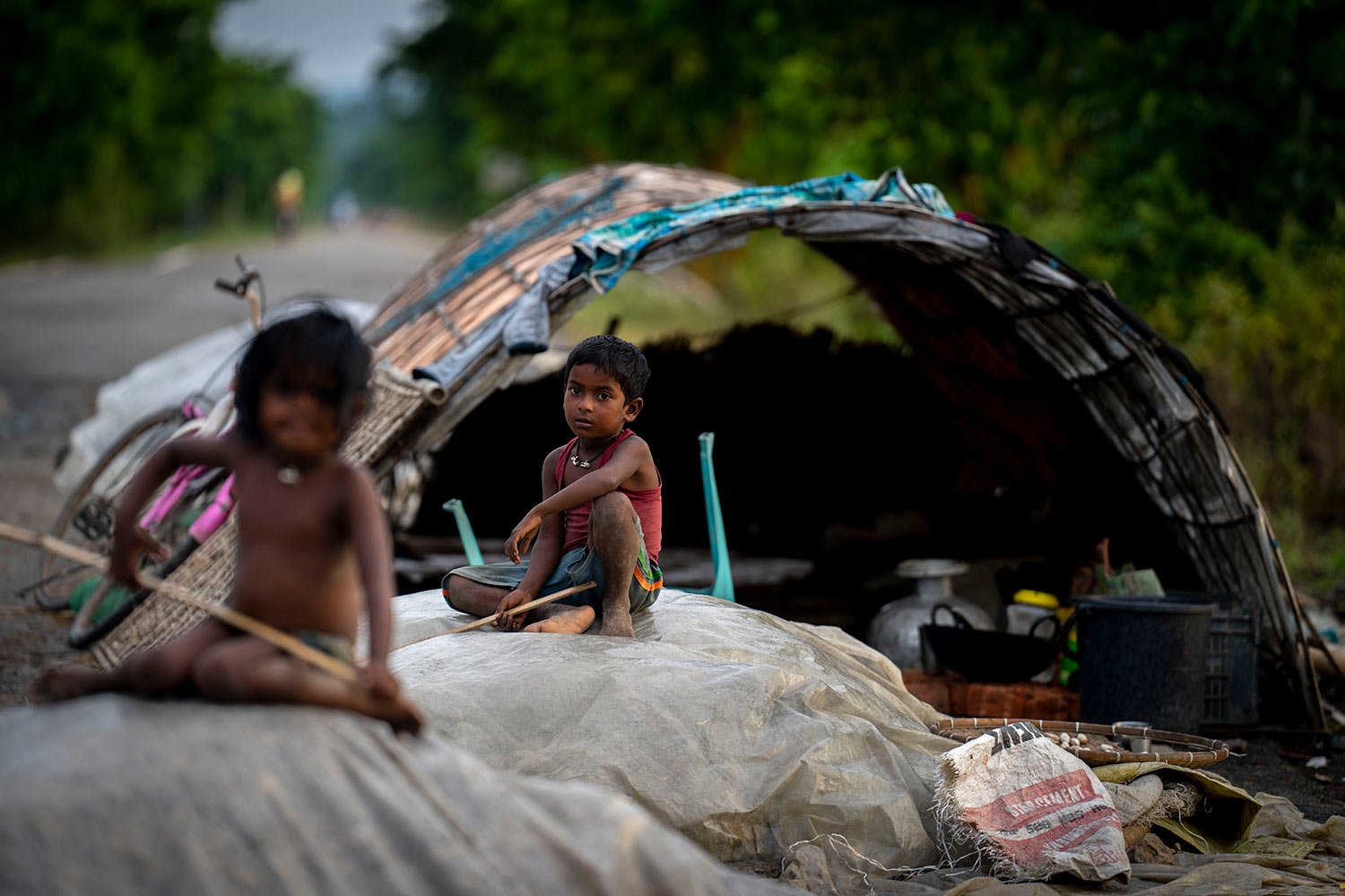  Flood affected children sit near their makeshift shelter on a road in Pobitora in Morigaon district east Gauhati, Assam state, India, Tuesday, June 28, 2022.  (AP Photo/Anupam Nath) 