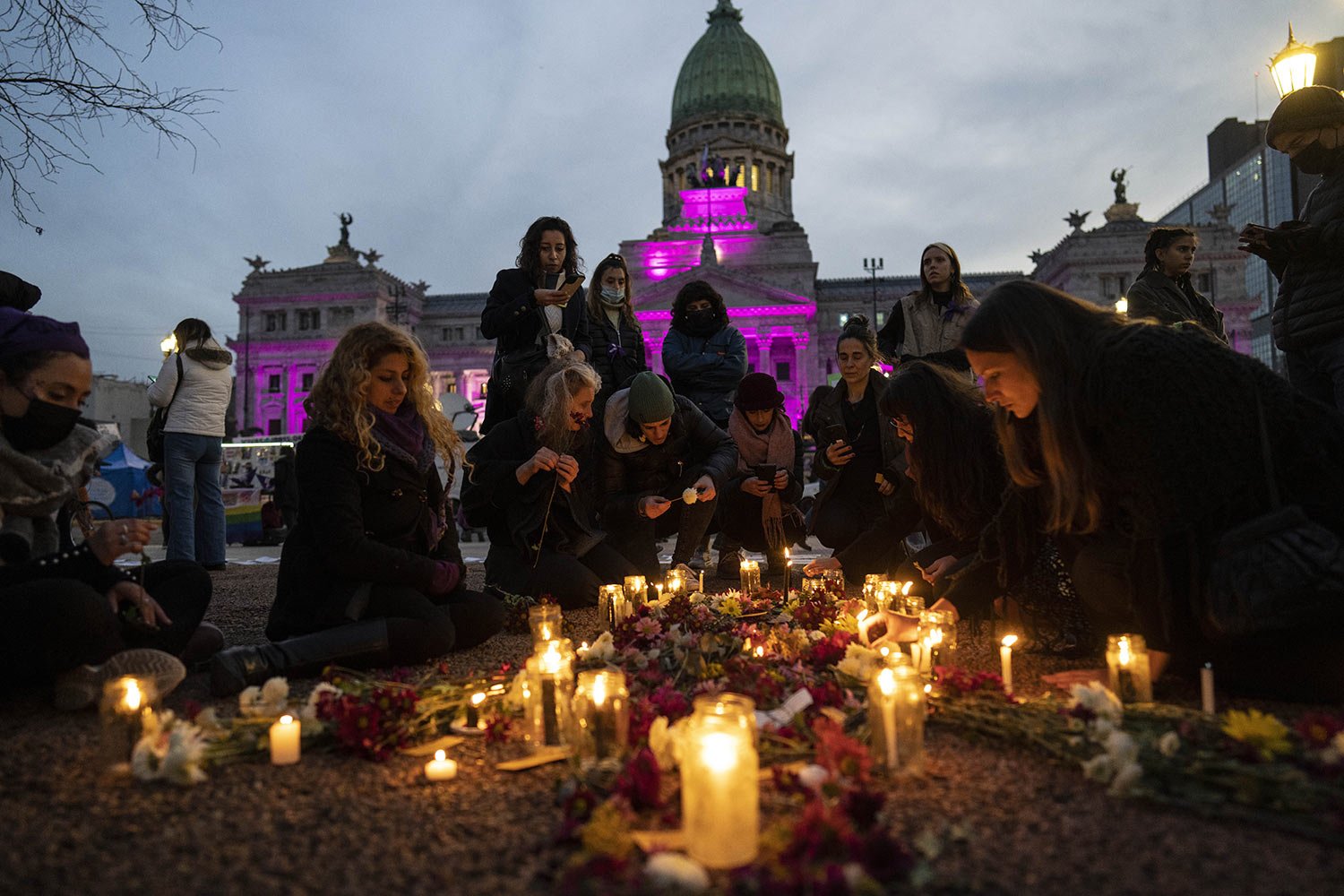  Women light candles during a march marking the 7th anniversary of the Ni Una Menos, or Not One Less, women's movement, in Buenos Aires, Argentina, Friday, June 3, 2022. (AP Photo/Rodrigo Abd) 