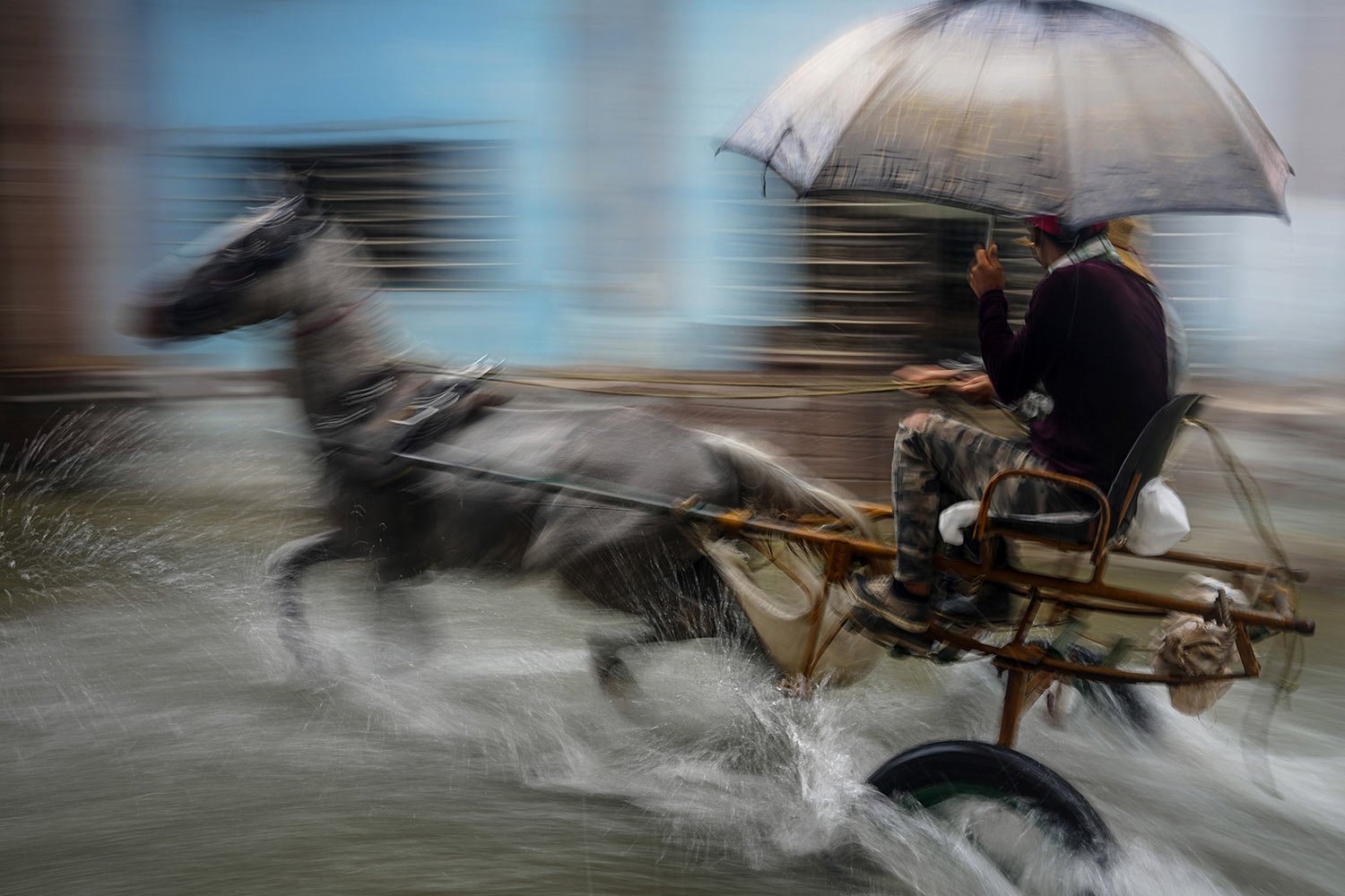  A horse pulls a buggy with passengers through a street flooded by heavy rains, in Havana, Cuba, Friday, June 3, 2022. (AP Photo/Ramon Espinosa) 