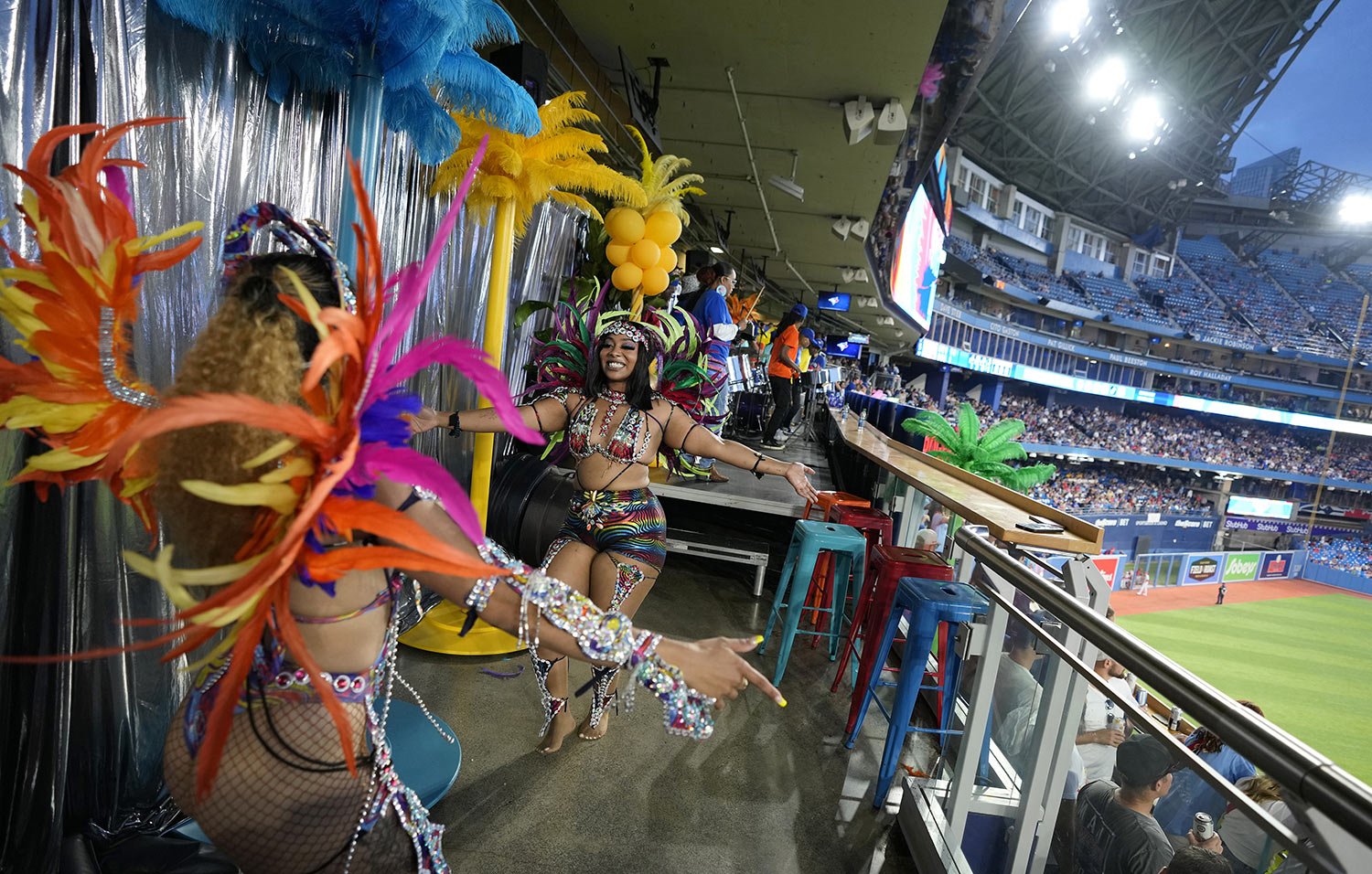  Carnival dancers perform during a break at a baseball game at Rogers Center in Toronto, Canada, Wednesday, July 27, 2022. (AP Photo/Kamran Jebreili) 