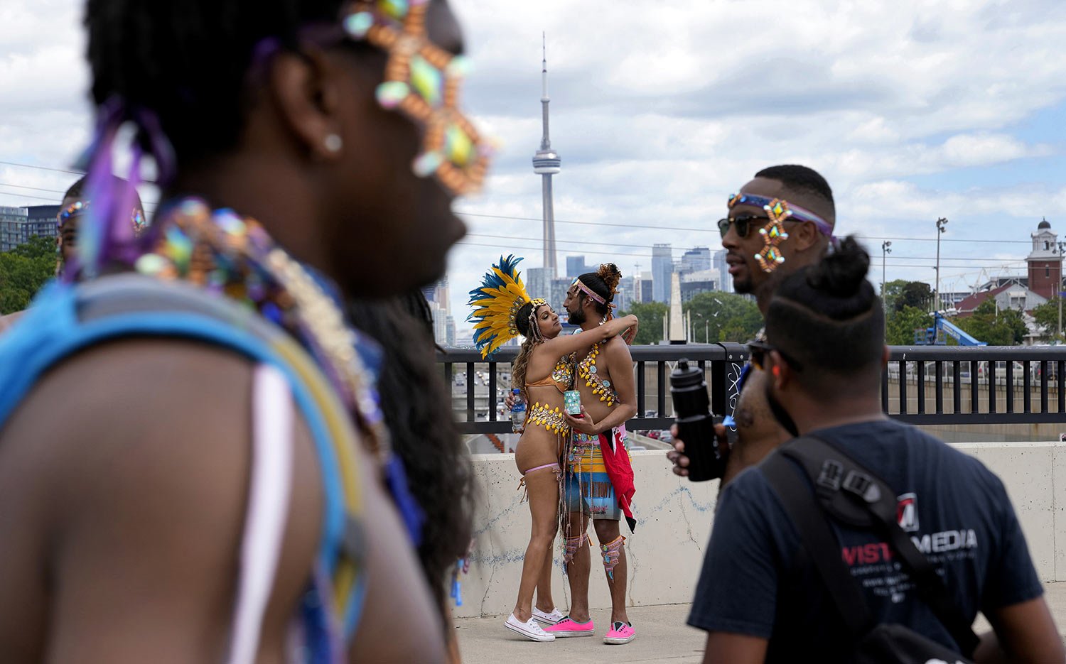  Masqueraders hug during the Caribbean Carnival parade in Toronto, Canada, Saturday, July 30, 2022. (AP Photo/Kamran Jebreili) 