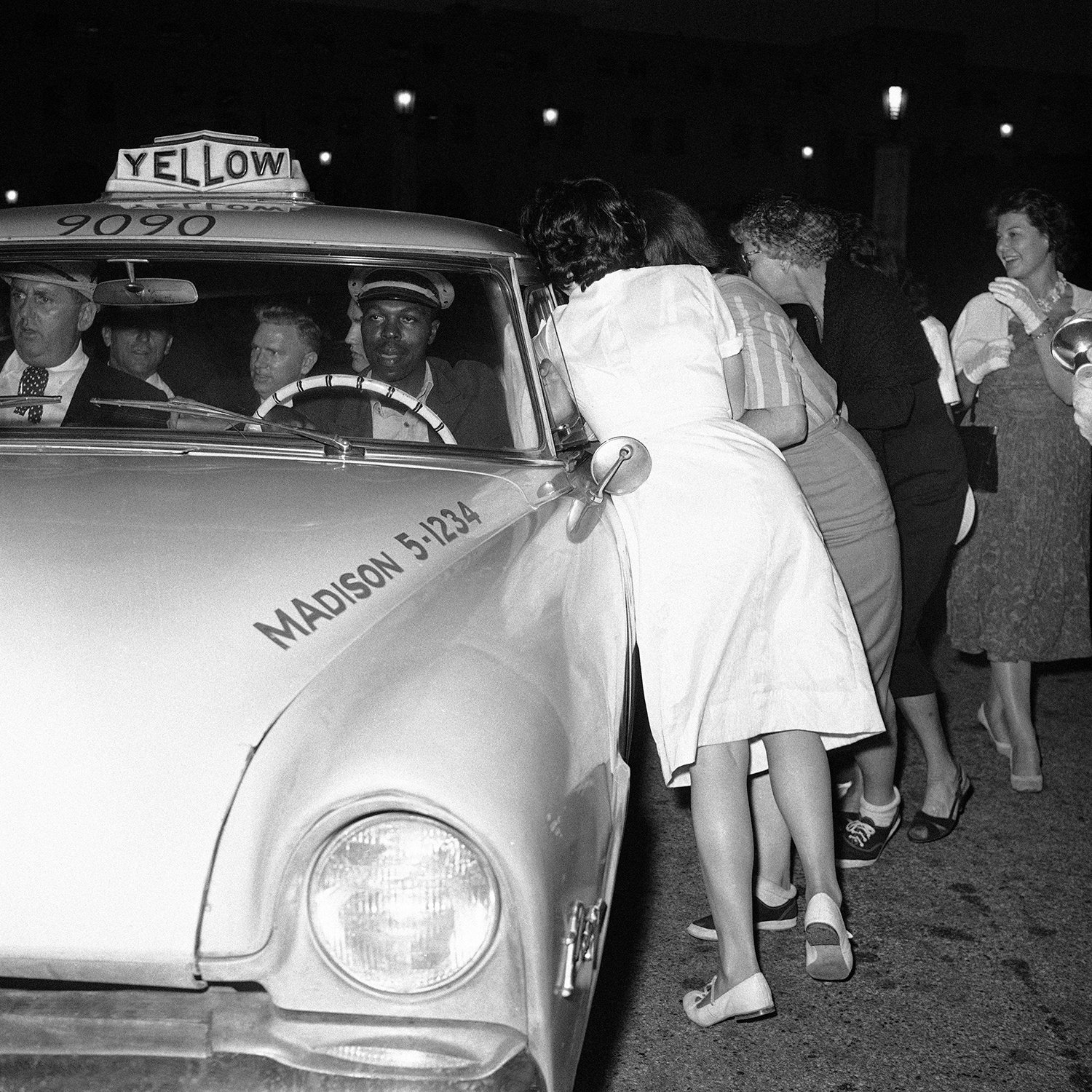  Teenage girls chase Elvis Presley’s cab as he left the Los Angeles Union Station after his press conference on April 20, 1960. Elvis Presley is seen slightly sitting behind cab driver. (AP Photo/HPM) 