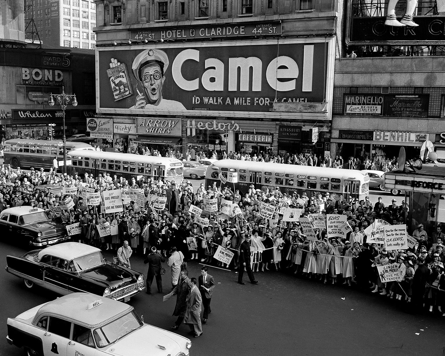  Some 1,000 teenagers, carrying placards, attend the unveiling of a 40-foot cardboard likeness of Elvis Presley on a marquee outside Paramount Theater, New York, on Oct. 28,1956. Failure of Elvis Presley to appear is said to have made it easier for 1