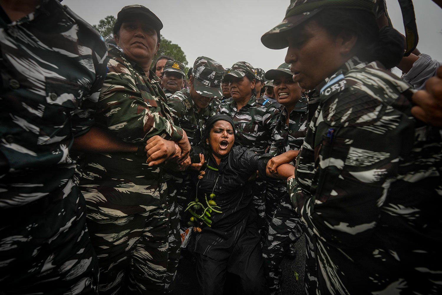  Indian paramilitary soldiers detain a lawmaker from India's opposition Congress party during a protest in New Delhi, India, Friday, Aug. 5, 2022. (AP Photo/Altaf Qadri) 