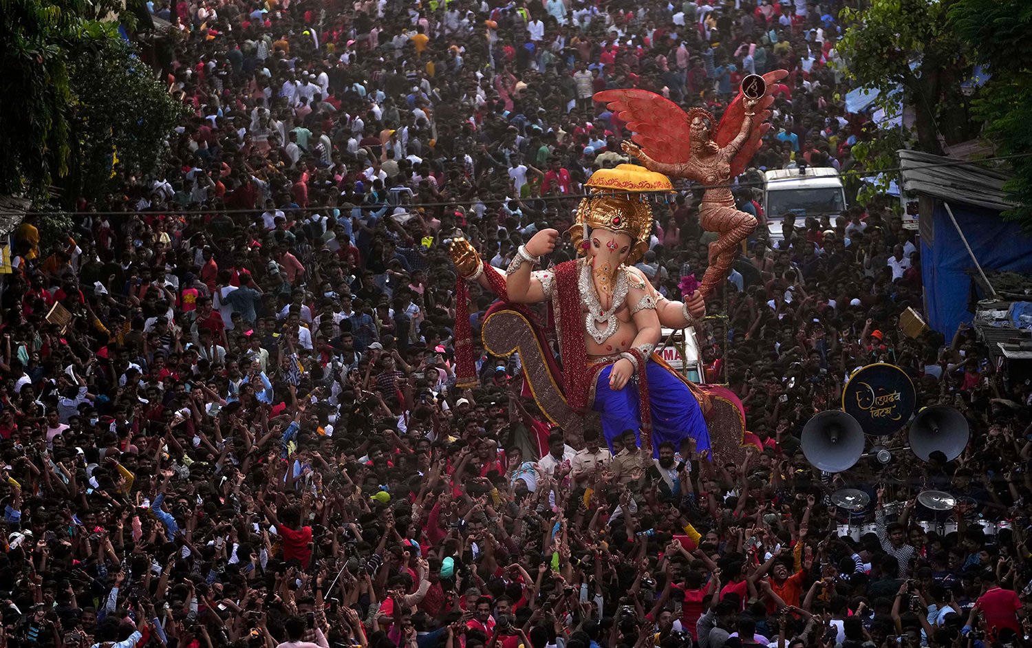  Devotees join a procession with an idol of lord Ganesha ahead of the upcoming ten-day-long Ganesh Chaturthi festival in Mumbai, India, Saturday, Aug. 27, 2022. (AP Photo/Rajanish kakade) 