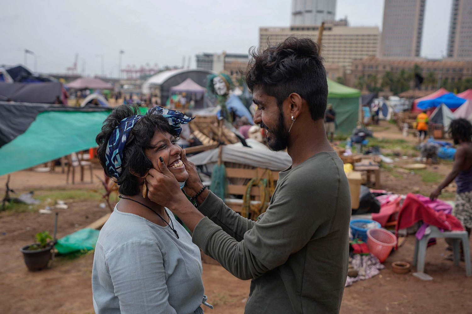  Protesters share a light moment before vacating a days-long protest camp outside the president's office in Colombo, Sri Lanka, Friday, Aug. 5, 2022. (AP Photo/Eranga Jayawardena) 