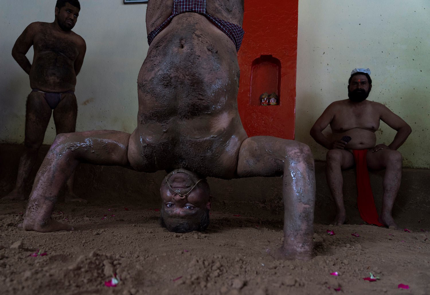  Traditional Indian wrestlers prepare for a bout during Nag Panchami festival in Prayagraj, India. Tuesday, Aug. 2, 2022.  (AP Photo/Rajesh Kumar Singh) 