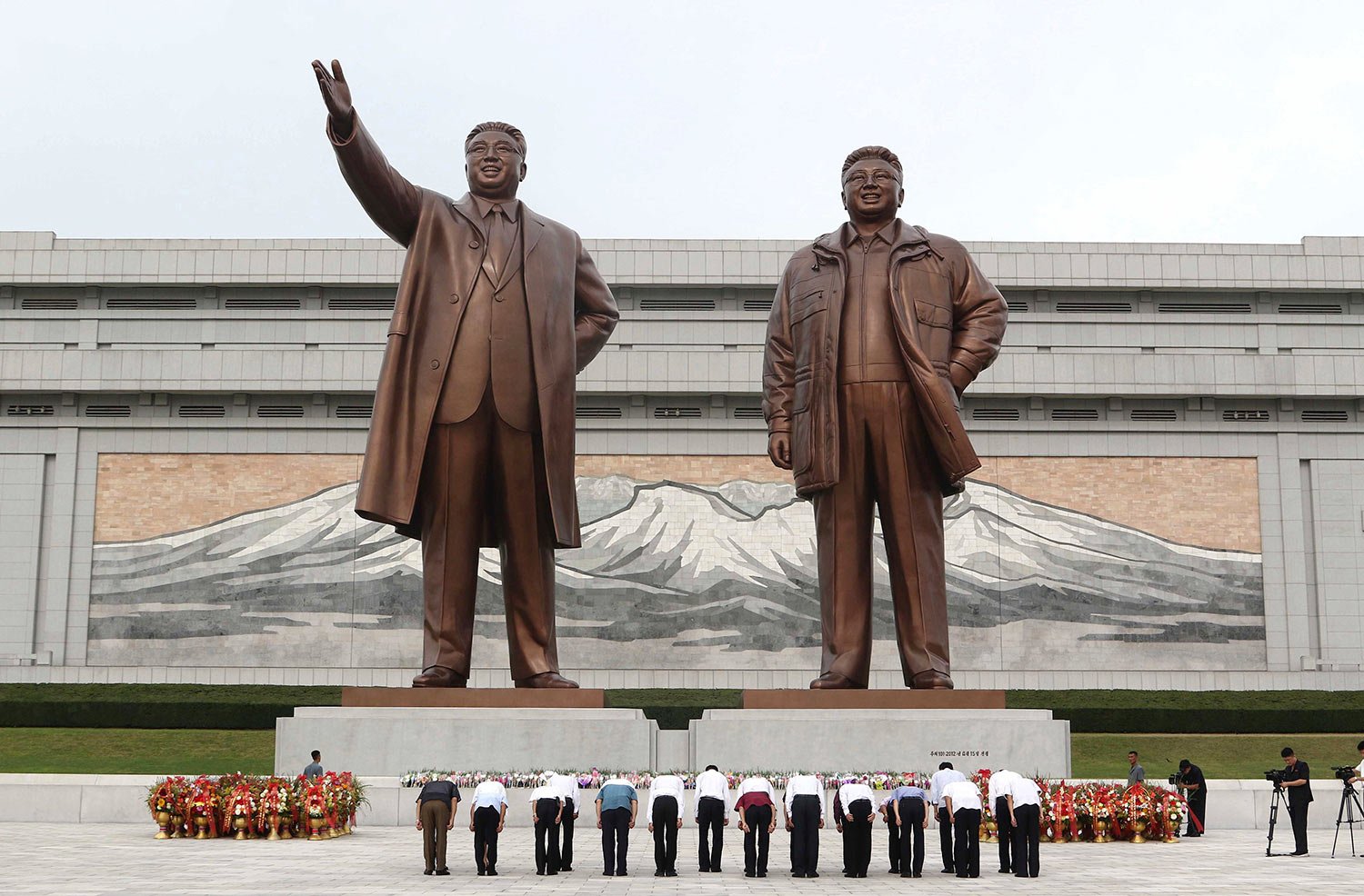  Pyongyang citizens pay tribute to the statues of their late leaders Kim Il Sung and Kim Jong Il on Mansu Hill on the occasion of the 62nd anniversary of Kim Jong Il's first field guidance for the revolutionary armed forces in Pyongyang, North Korea 