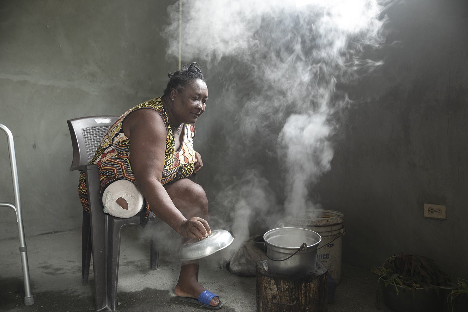  Duverseau Marie Cephta, whose leg was amputated when she was injured by last year's 7.2-magnitude earthquake, cooks in her home in the Lagodray area of Les Cayes, Haiti, Friday, Aug. 19, 2022. (AP Photo/Odelyn Joseph) 