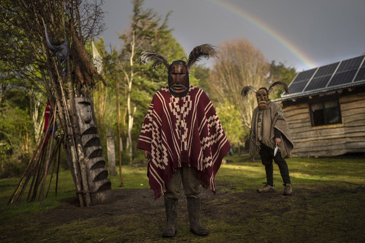  Mapuche men pose for a photo wearing kollon, or ceremonial masks, outside their home in Carimallin, southern Chile, on Friday, July 1, 2022. They are in charge of driving away negative energies during the multiday ceremonies of We Tripantu, the Mapu