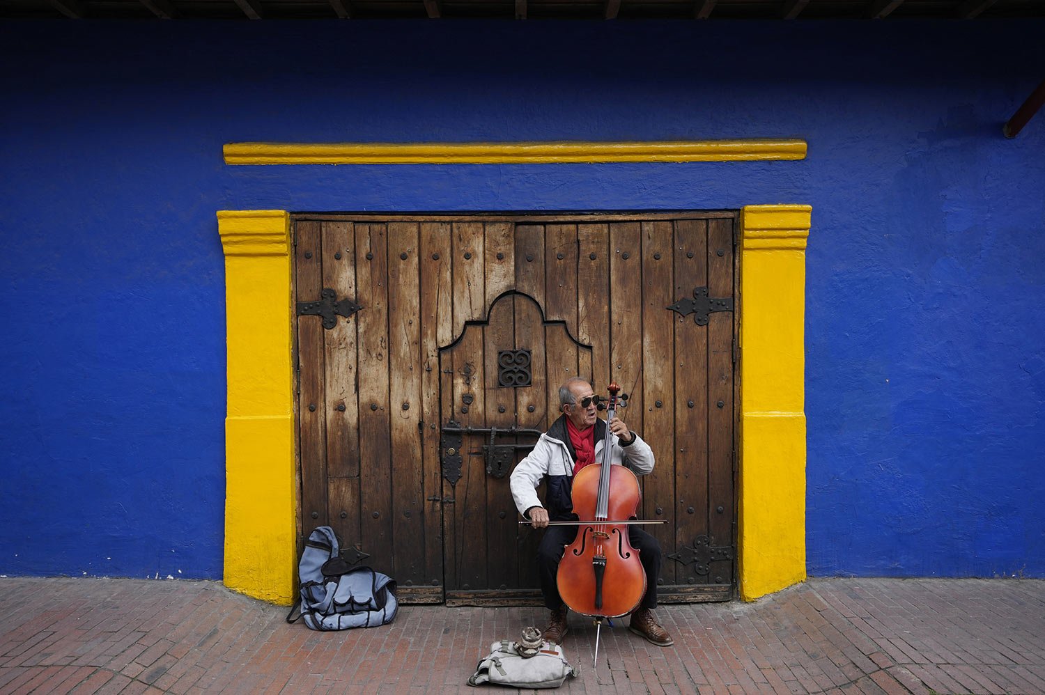  Fabio Guarin, 76, plays a cello for tips which he said he uses to buy his meals in the La Candelaria neighborhood of Bogota, Colombia, Thursday, Aug. 4, 2022. (AP Photo/Fernando Vergara) 