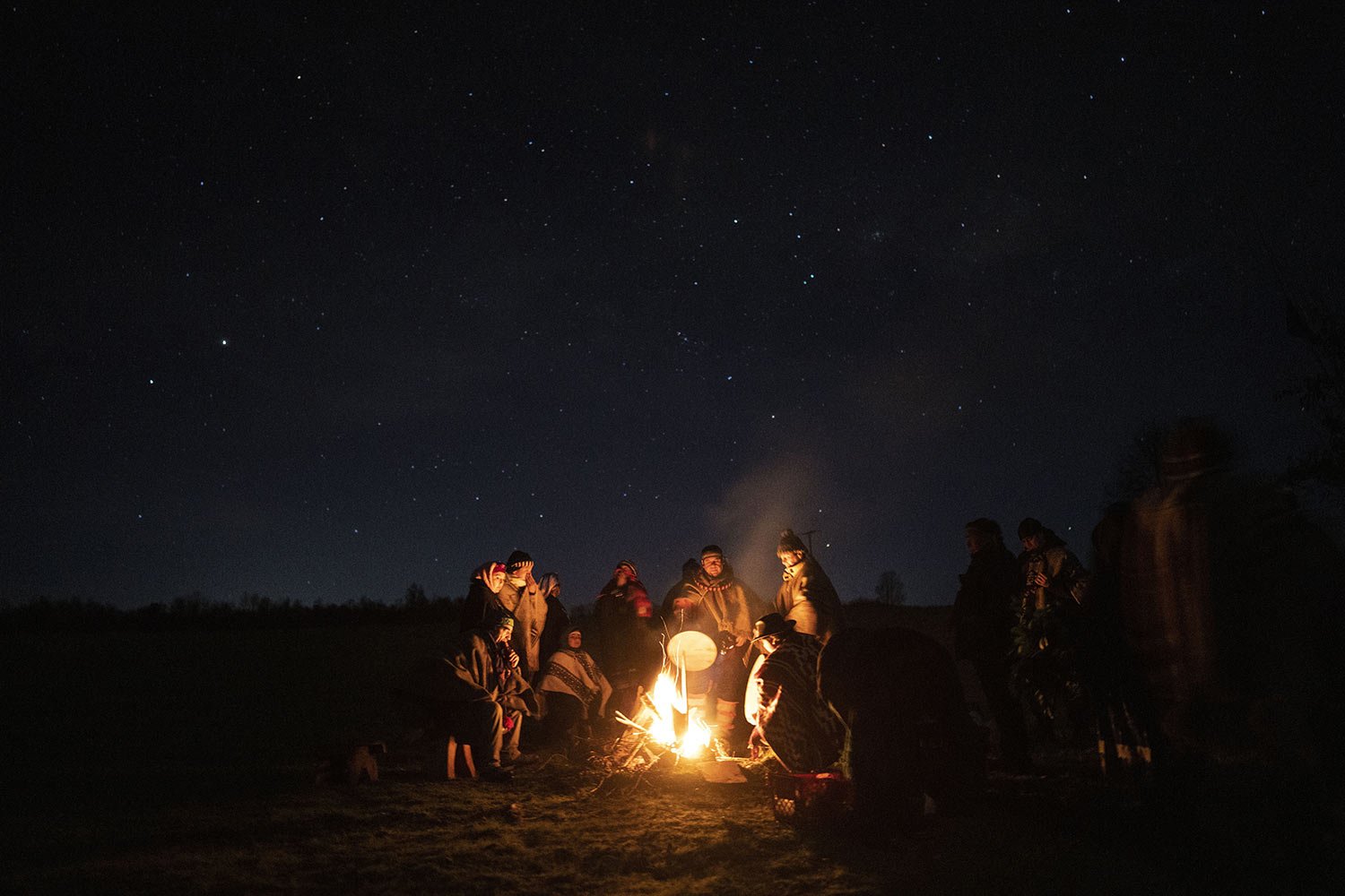  Huenchupan family members gather around a campfire as part of celebrations of We Tripantu, the Mapuche new year, in Lof Soyinka, Los Rios, southern Chile, on Wednesday, June 22, 2022. (AP Photo/Rodrigo Abd) 