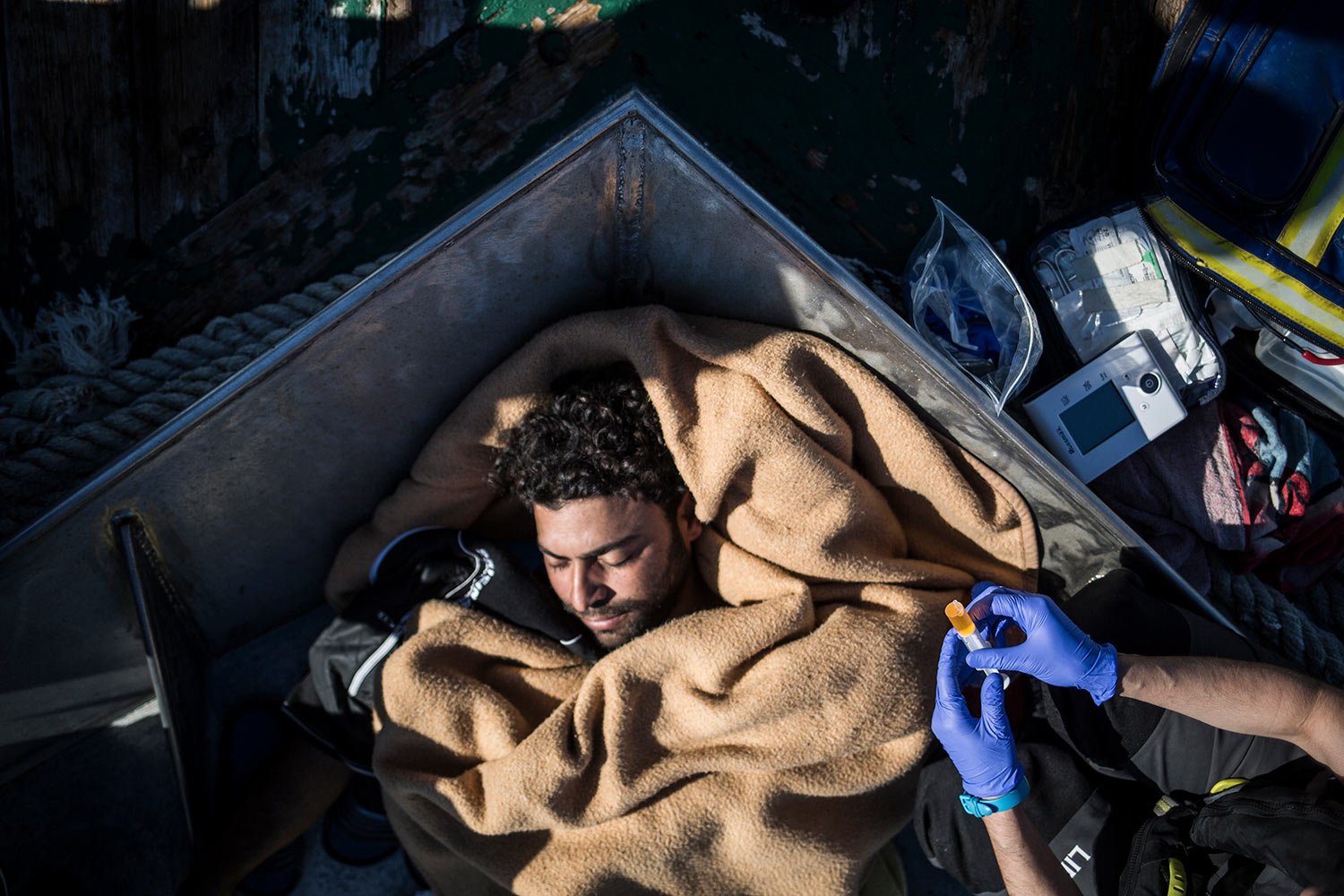  A sick migrant from Egypt is given medical treatment on the deck of the Nuestra Madre de Loreto Spanish fishing vessel carrying 12 migrants rescued off the coast of Libya, Nov. 30, 2018. (AP Photo/Javier Fergo) 