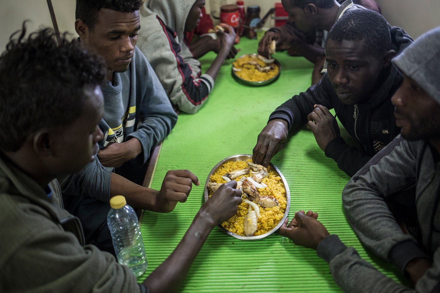  Migrants eat a meal aboard the Spanish fishing vessel Nuestra Madre de Loreto carrying migrants rescued off the coast of Libya, Dec. 1, 2018. One of the migrants was evacuated by helicopter for medical reasons.  (AP Photo/Javier Fergo) 