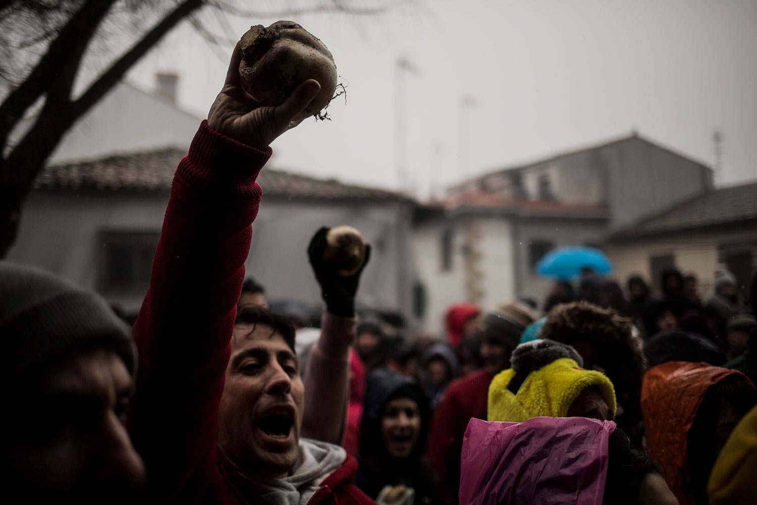  In this Jan. 19, 2019 photo, people hold up turnips before throwing them at the Jarramplas as he makes his way through the streets beating his drum during the Jarramplas festival in the tiny southwestern Spanish town of Piornal, Spain. (AP Photo/Jav