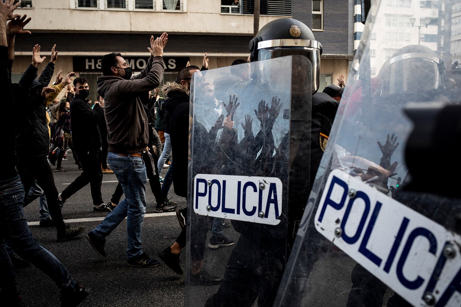  Protesters, left, march during a strike organized by metal workers in Cadiz, southern Spain, Nov. 23, 2021. (AP Photo/Javier Fergo) 