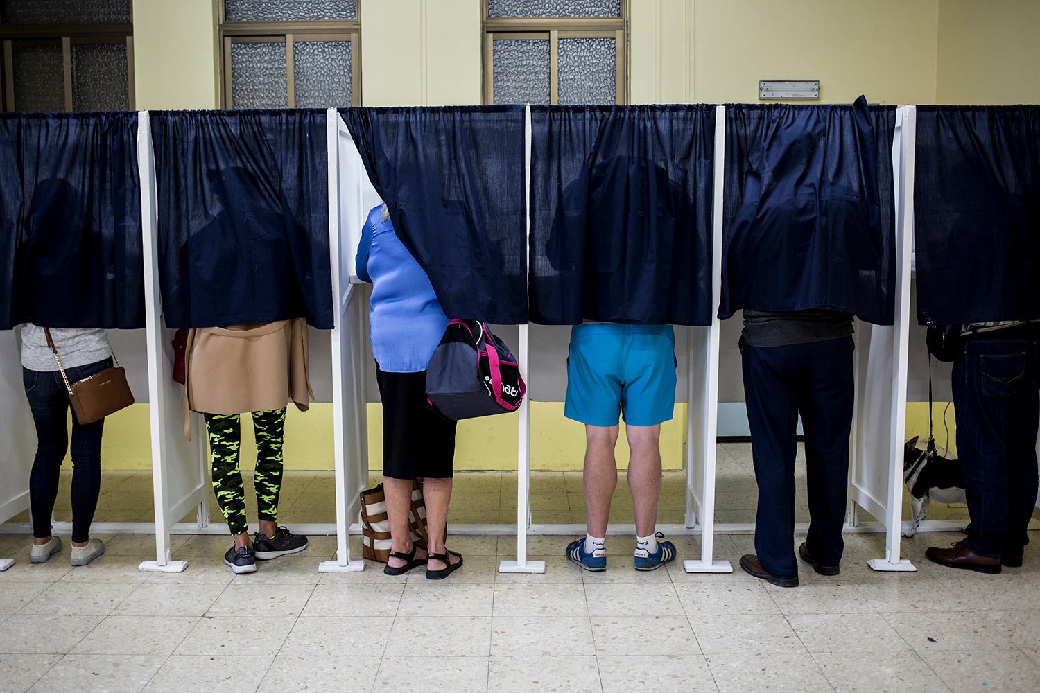  People use voting booths at a pooling station during general elections in Gibraltar, Oct. 17, 2019. (AP Photo/Javier Fergo) 