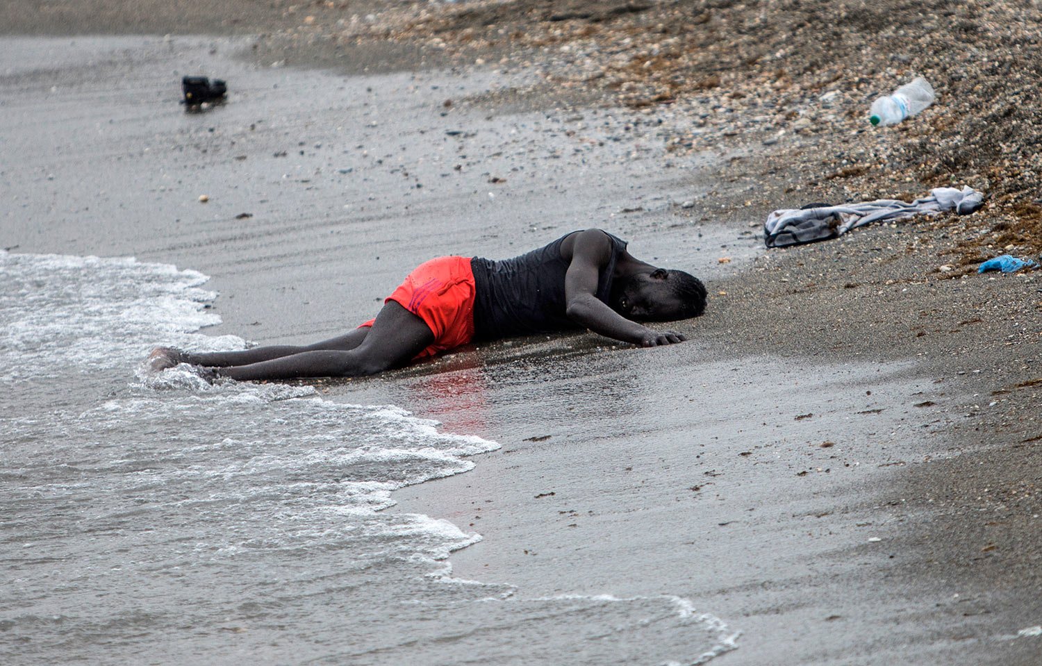  A man lies on the ground on the beach after swimming to the area at the border of Morocco and Spain, at the Spanish enclave of Ceuta, May 18, 2021. (AP Photo/Javier Fergo) 