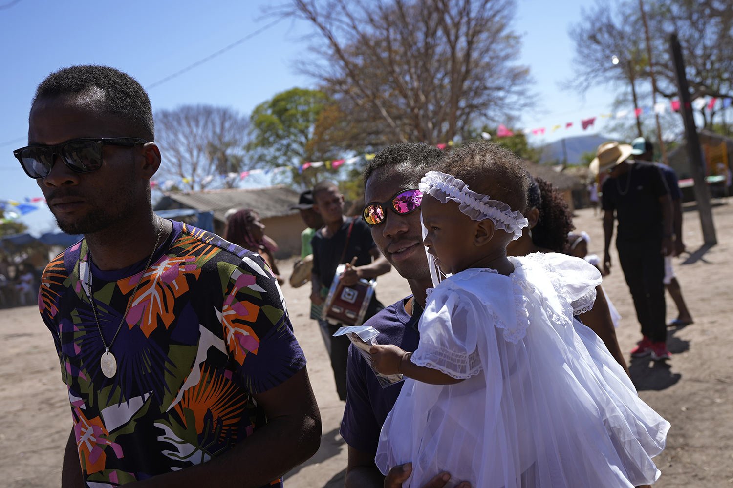  Residents leave a baptism ceremony at the end of a week-long pilgrimage honoring the patron saint in Cavalcante, Goias state, Brazil, Aug. 15, 2022. (AP Photo/Eraldo Peres) 