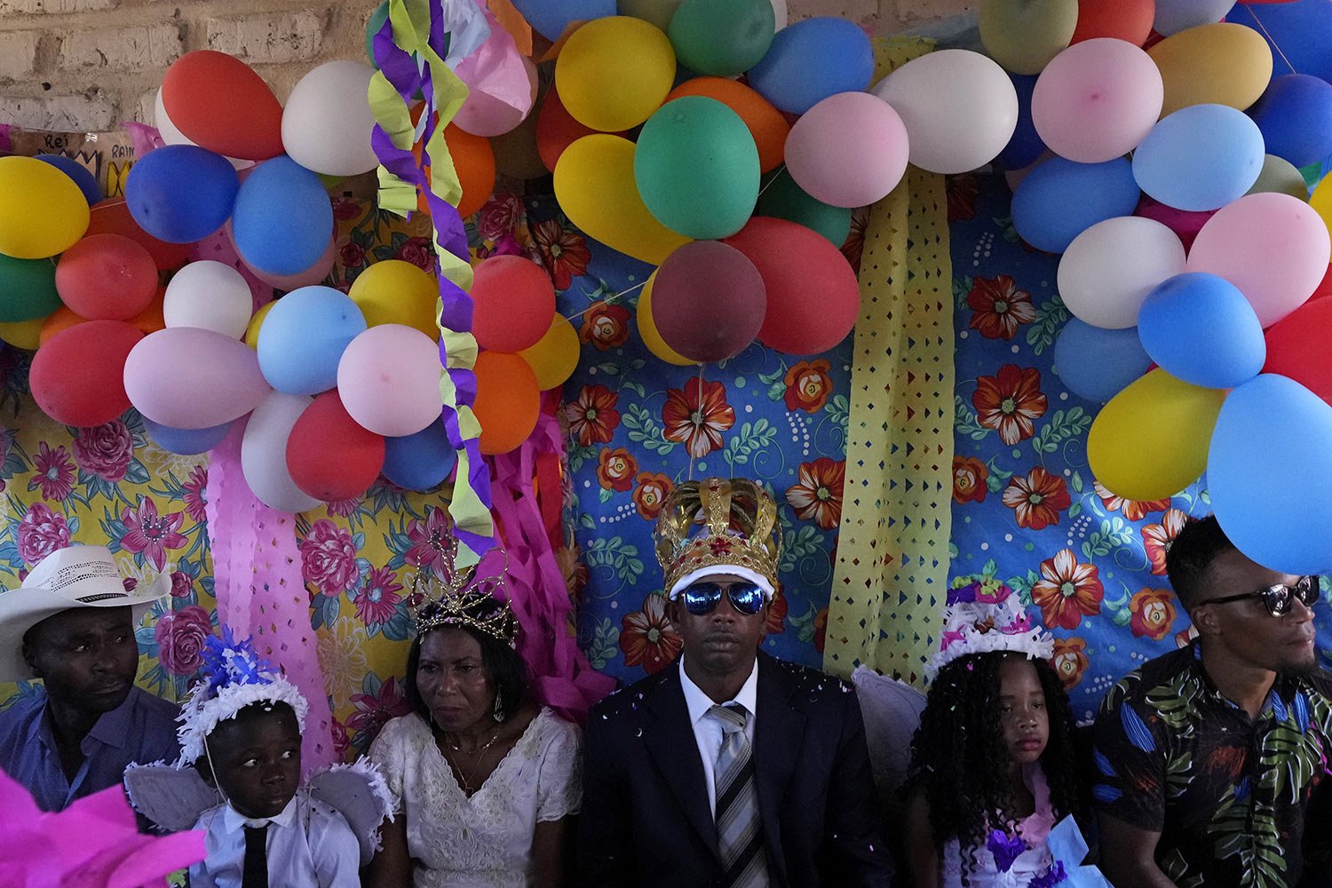  Adonildes da Cunha, center right, sits with Nilda dos Santos as they wear their Emperor and Queen crowns after attending a religious Mass at the end of a week-long pilgrimage honoring the patron saint in Cavalcante, Goias state, Brazil, Aug. 15, 202