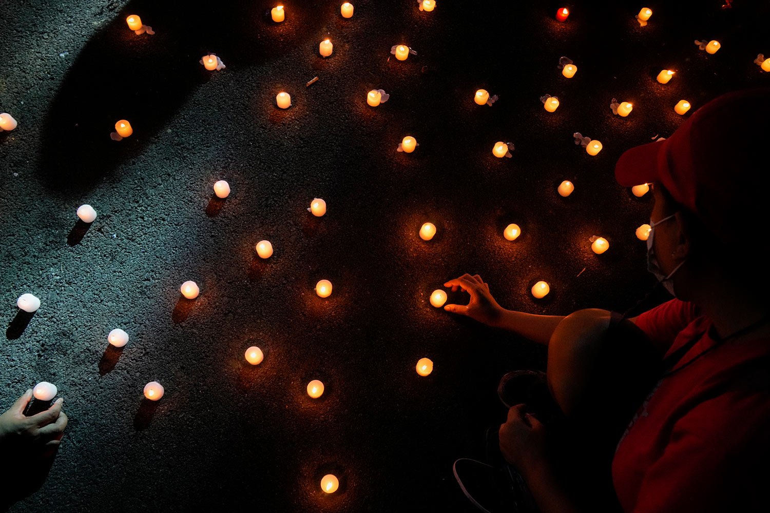  Human rights groups lights candles as they mark the 50th anniversary of martial law at the University of the Philippines in Metro Manila, Philippines, Wednesday, Sept. 21, 2022. (AP Photo/Aaron Favila) 