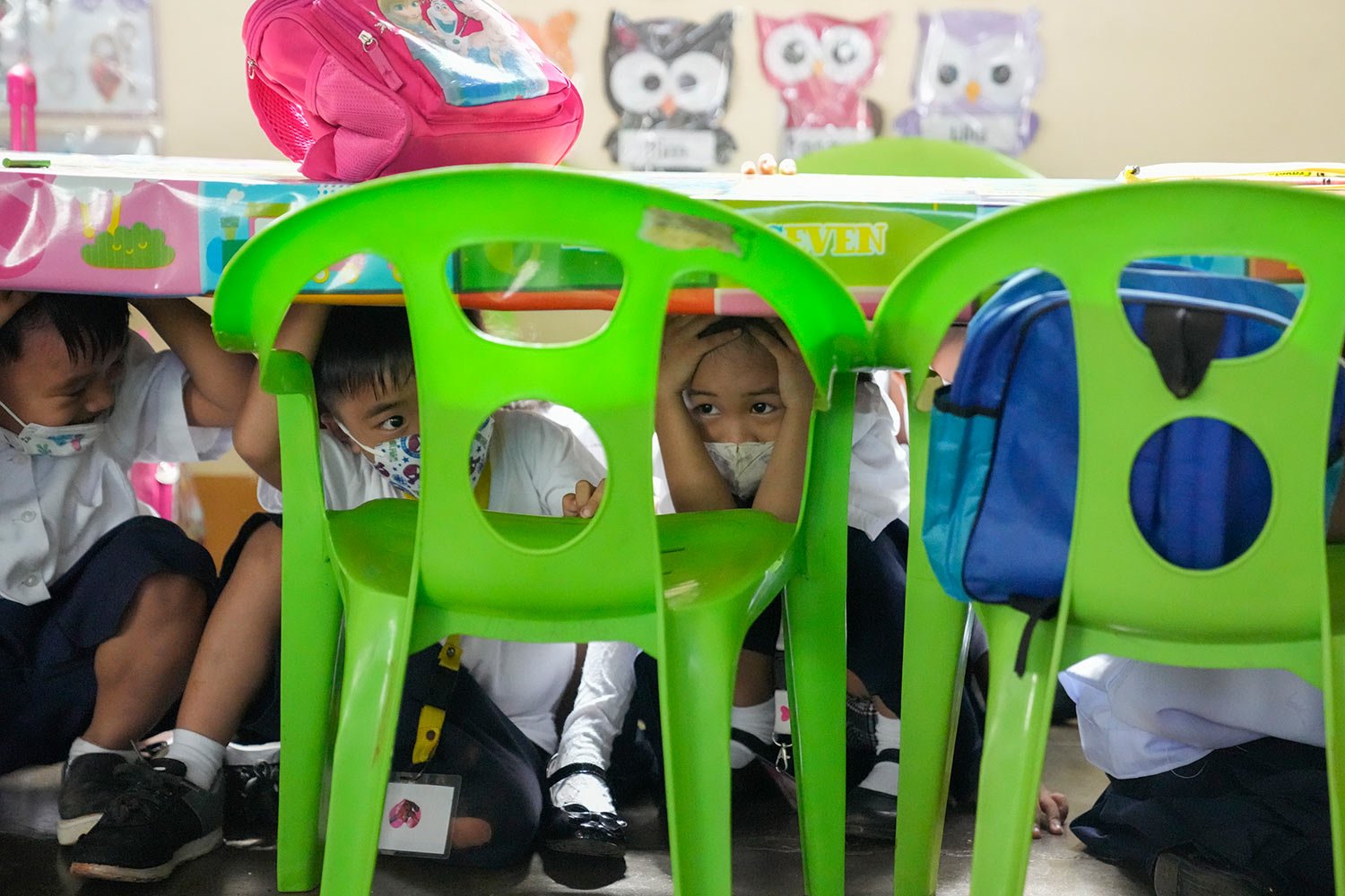  Students duck under a table during an earthquake drill at an elementary school in Metro Manila, Philippines on Thursday Sept. 8, 2022. (AP Photo/Aaron Favila) 