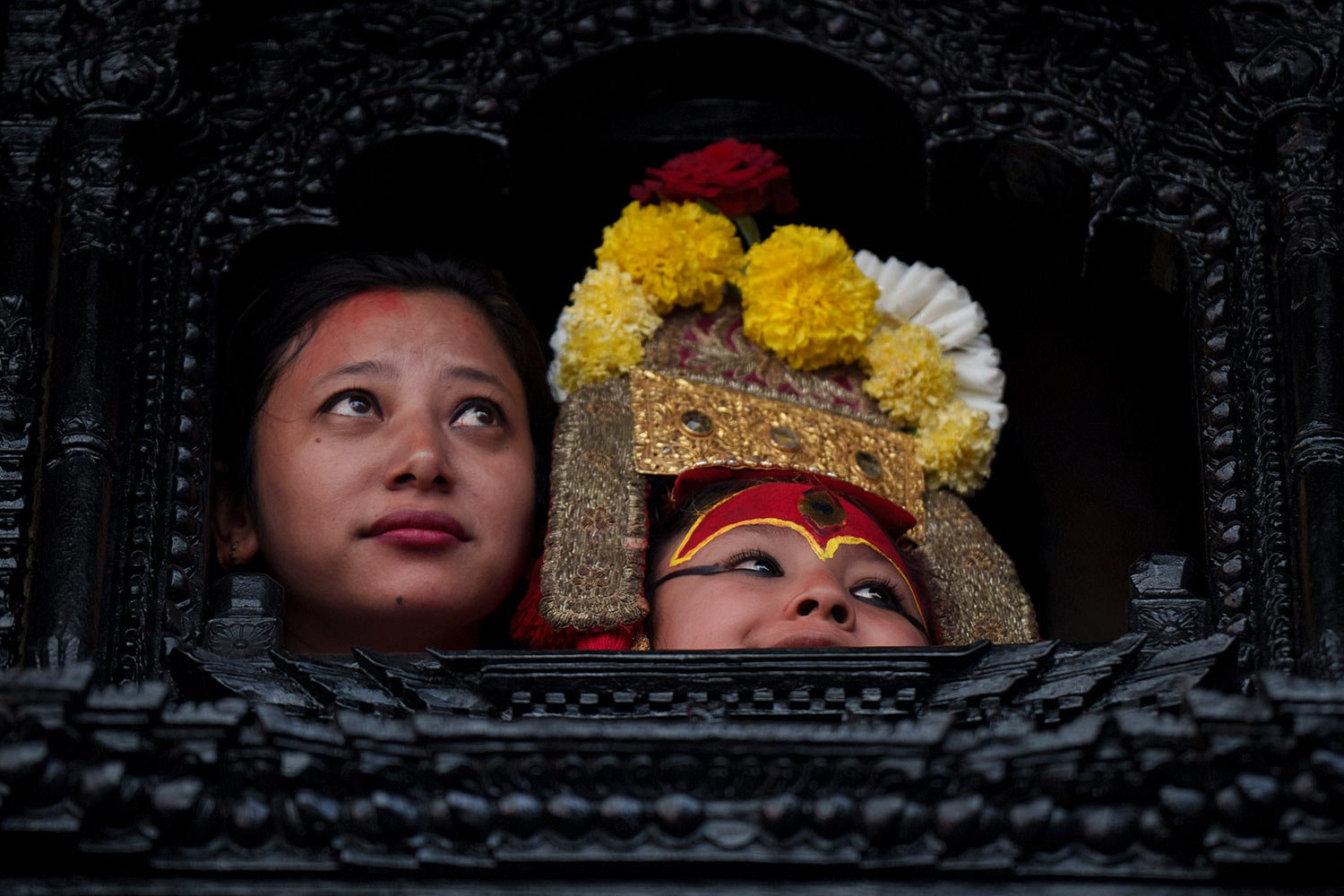  Living god Ganesh looks out from a window during the annual Indra Jatra festival in Kathmandu, Nepal, Friday, Sept. 9, 2022.  (AP Photo/Niranjan Shrestha) 