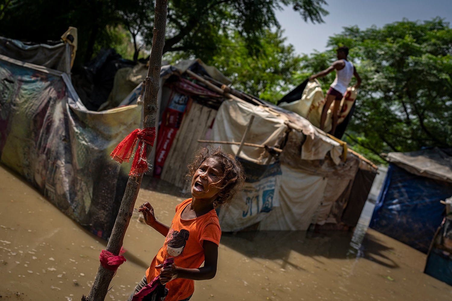  A young girl sobs as she stands outside her shanty after floodwaters inundated homes along the banks of the Yamuna River, in New Delhi, India, Tuesday, Sept. 27, 2022. (AP Photo/Altaf Qadri) 