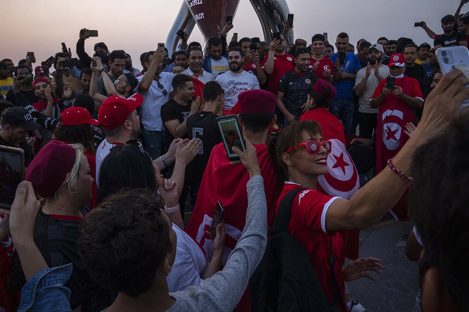  Tunisian football fans celebrate their team, who will be competing in the World Cup finals for a sixth time, in front of the official FIFA World Cup Countdown Clock on Doha's corniche, 30 days ahead until the start of the World Cup, in Qatar, Friday