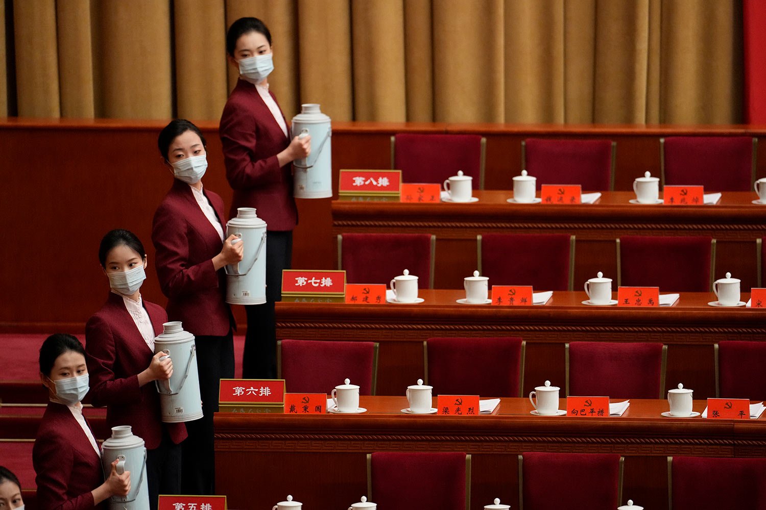  Hostesses prepare drinks at the Great Hall of the People before the opening ceremony for the 20th National Congress of China's ruling Communist Party in Beijing, China, Sunday, Oct. 16, 2022.  (AP Photo/Mark Schiefelbein) 