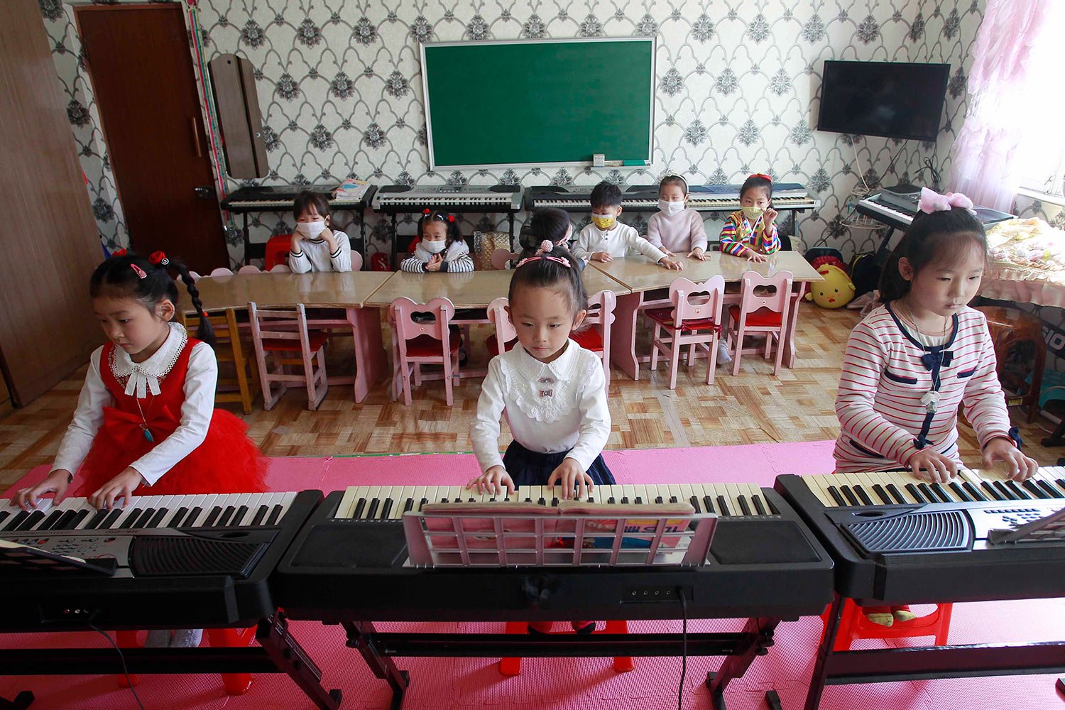  Young girls practice piano at the Ryonmot Kindergarten in the Sosong District of Pyongyang, North Korea, Monday, Oct. 17, 2022. (AP Photo/Cha Song Ho) 