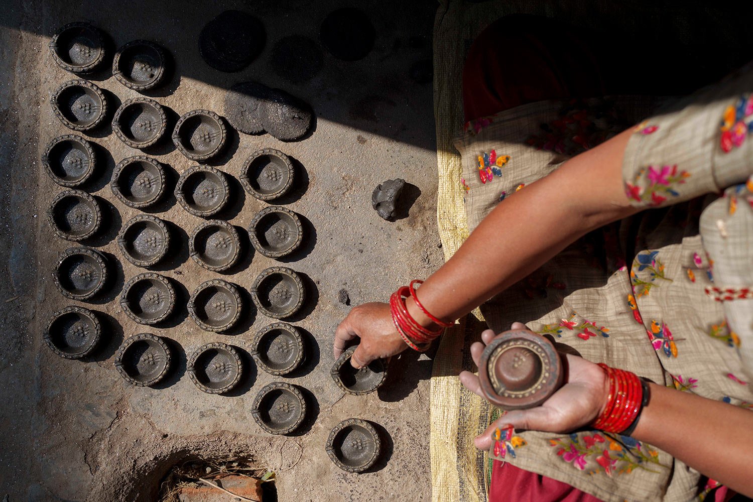  A potter makes earthen lamps for the upcoming Tihar festival in Bhaktapur, Nepal, Friday, Oct. 21, 2022. (AP Photo/Niranjan Shrestha) 