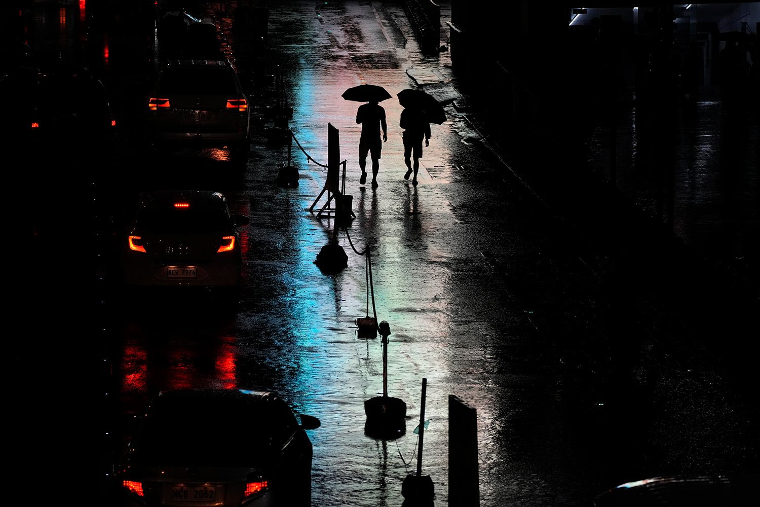  Men walk under the rain caused by Tropical Storm Nalgae in Manila, Philippines on Saturday Oct. 29, 2022. (AP Photo/Aaron Favila) 