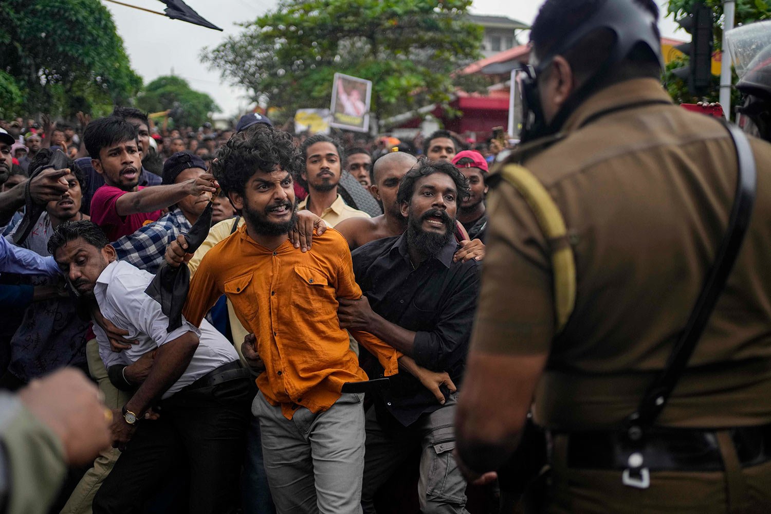  Members of Sri Lanka's Inter University Students Federation heckle a police officer during a protest held outside a state run university demanding the release of student union leaders who are in custody in Kelaniya, outskirts of Colombo, Sri Lanka, 