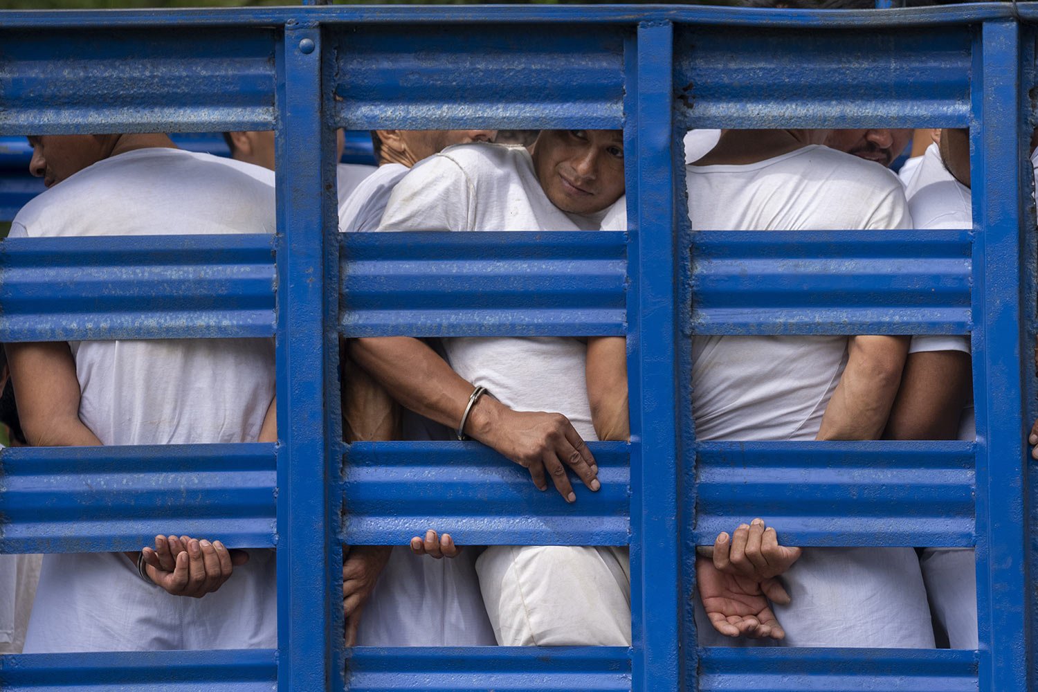  Men detained under the "state of exception" are transported to a detention center in a cargo truck, in Soyapango, El Salvador, Friday, Oct. 7, 2022. The arrests under the "state of exception" of more than 55,000 people have swamped an already overwh