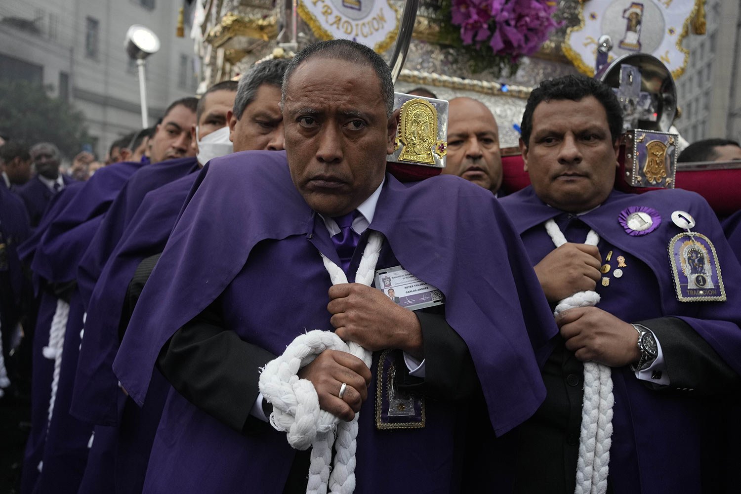  "Cargadores" or carriers, shoulder a religious float supporting The Lord of Miracles religious icon during a procession marking the the nation's patron saint feast day in Lima, Peru, Tuesday, Oct. 18, 2022. (AP Photo/Martin Mejia) 